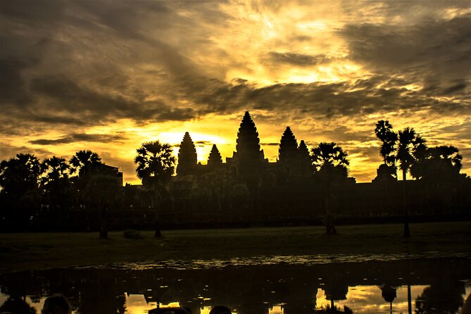 The towers of Angkor Wat coming up out of the dark behind the north pool