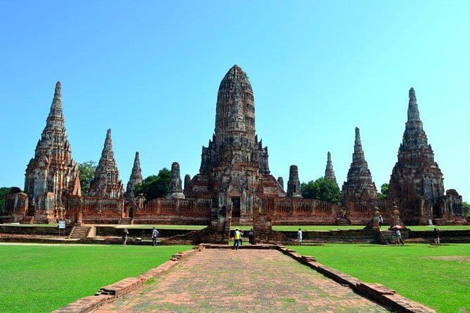Bangkok History Temples Markets and Food Tasting - Tha Chang Pier, ferry travel, and a local market snack