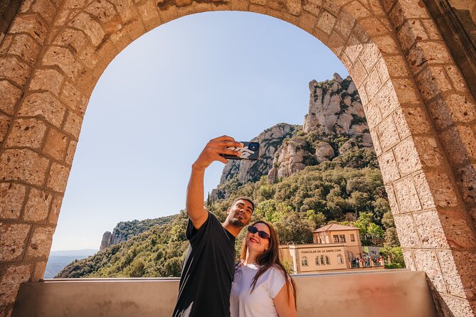 Montserrat Monastery Visit and Local Brunch from Barcelona - Reaching the monastery beneath Montserrat’s peaks