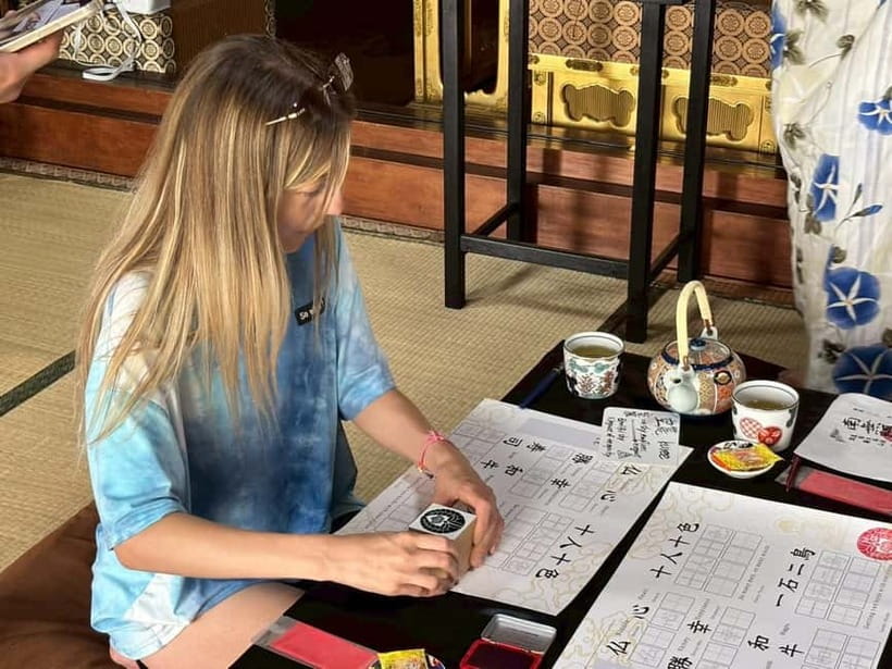 Osaka: Temple Tour and Traditional Calligraphy Lesson - Learning the basic strokes of Japanese calligraphy